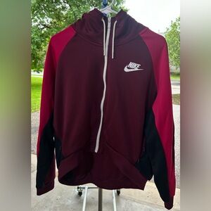 Two toned Maroon and black Nike zip, with zippered pockets.